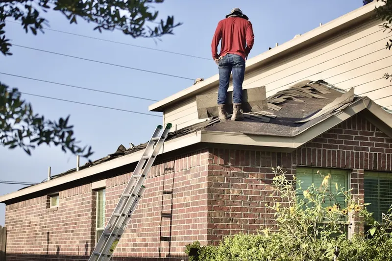Professional roofer working on a residential roof in Sarles Corners